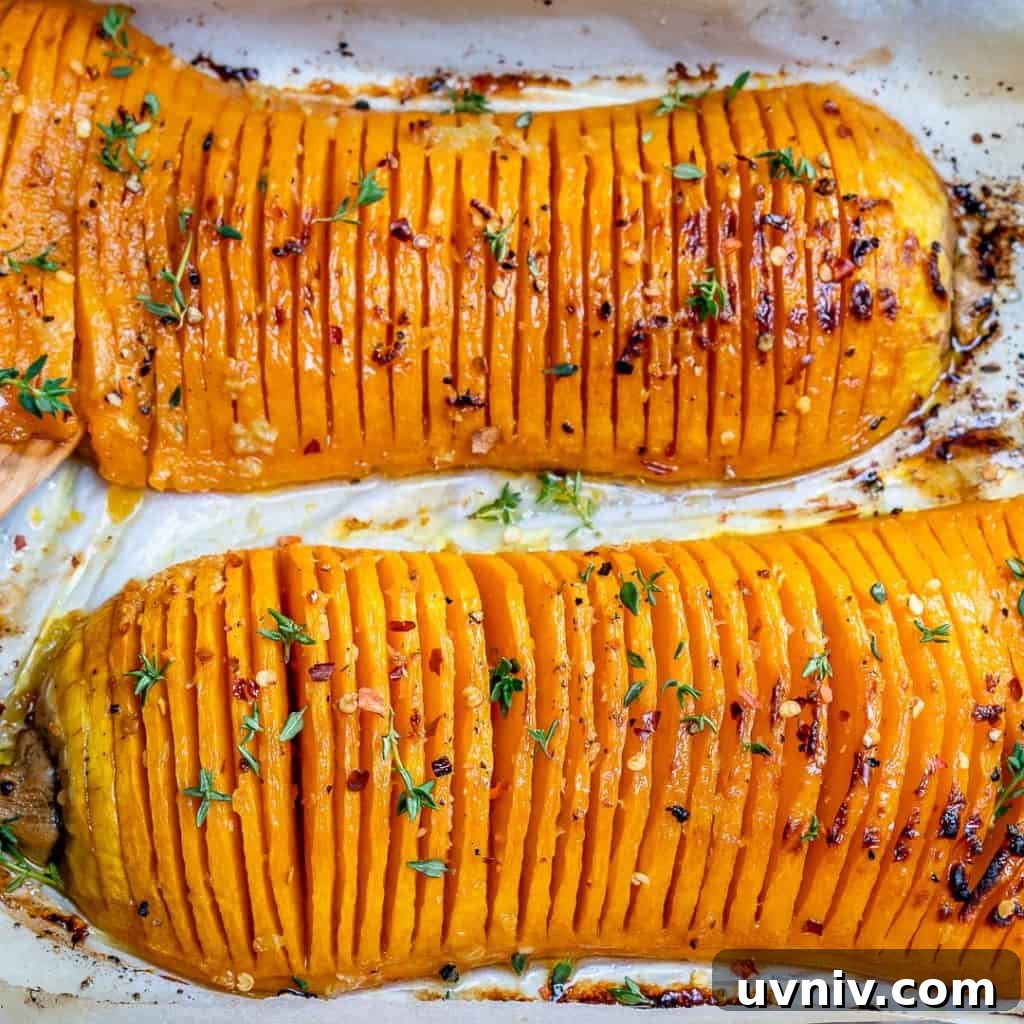 Crispy Hasselback Butternut Squash with Herb Butter 5 side shot of roasted Hasselback butternut squash on a roasting pan