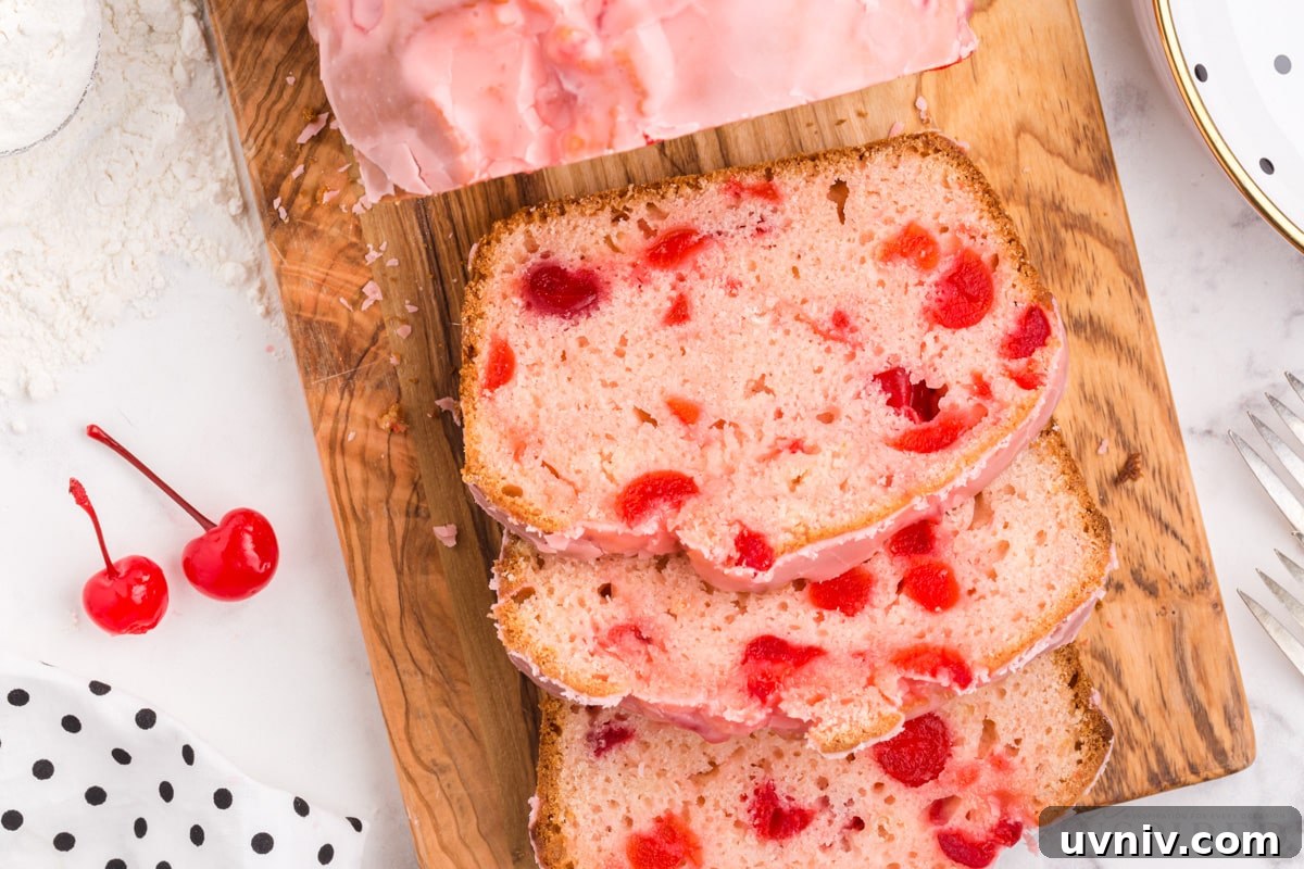 top close up of a cutting board with a loaf of cherry bread cut in to slices