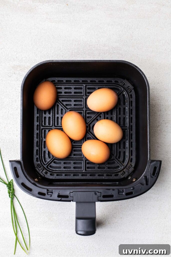 Perfect Air Fryer Hard-Boiled Eggs That Peel Easily 5 Eggs in an air fryer basket.