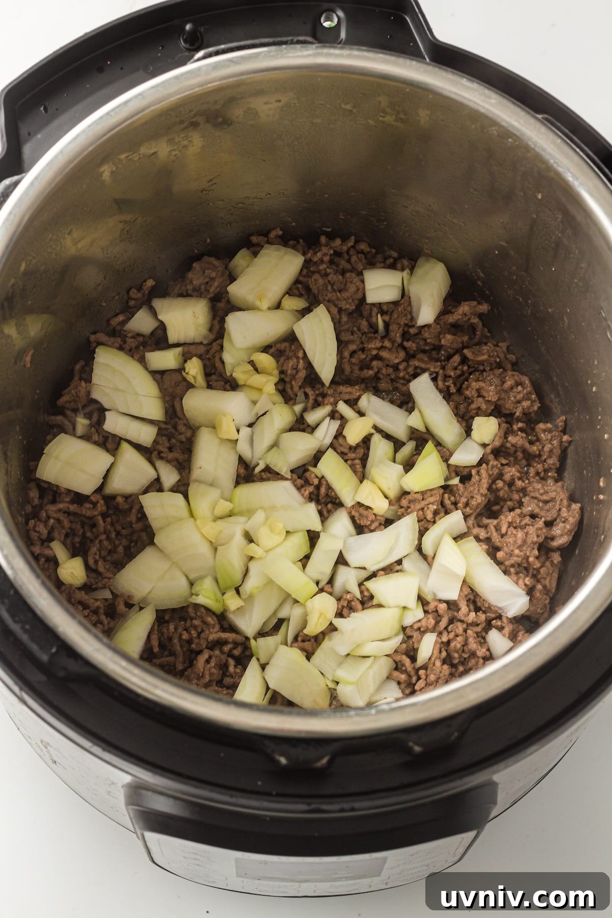Instant Pot Spaghetti with Savory Meat Sauce 5 Diced onion and minced garlic added to browned ground beef in the Instant Pot for extra flavor.