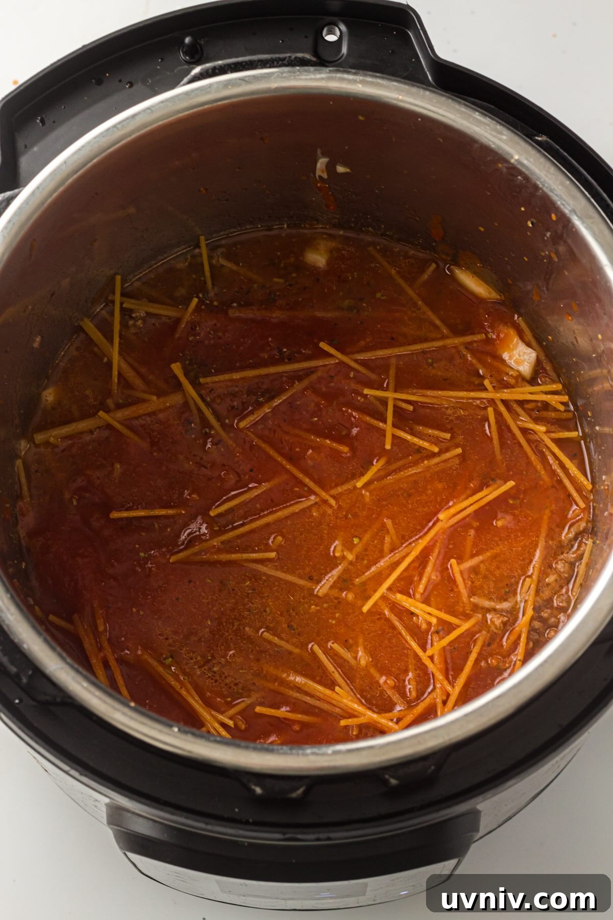 Instant Pot Spaghetti with Savory Meat Sauce 7 Jarred marinara sauce added to uncooked spaghetti noodles in the Instant Pot