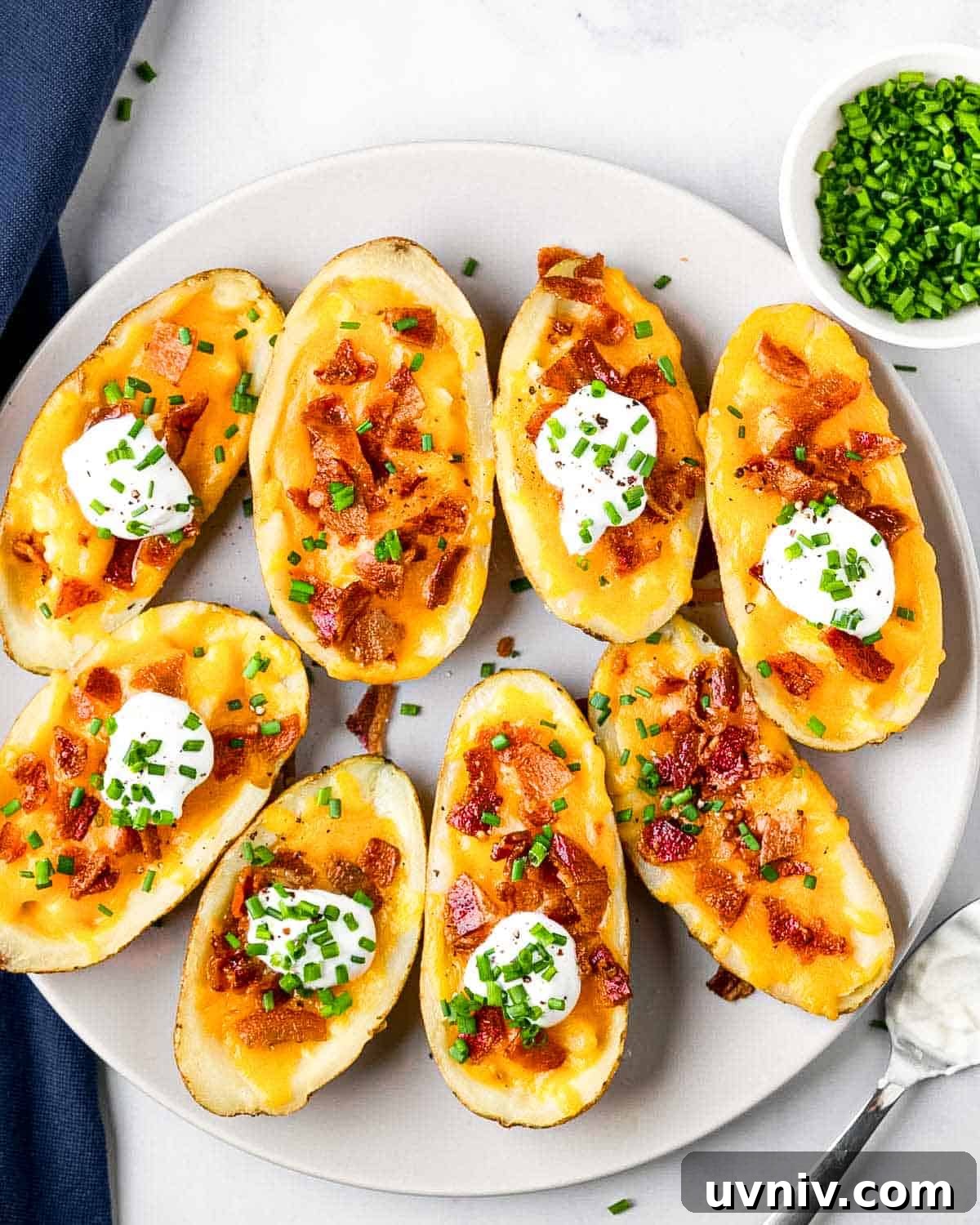 Crispy Air Fryer Potato Skins with Cheesy Bacon Filling 10 plate of 8 air fryer potato skins and toppings.