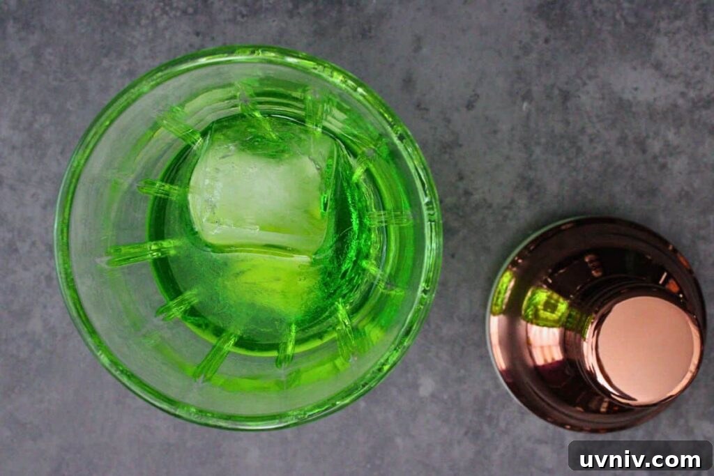 Slimer Ghostbusters Shot Recipe for a Spooky Halloween Party 5 add midori and peach schnapps to cocktail shaker