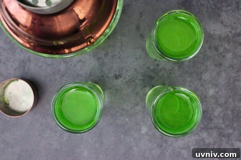 Slimer Ghostbusters Shot Recipe for a Spooky Halloween Party 6 shake and strain green ghostbusters shot mixture into shot glasses