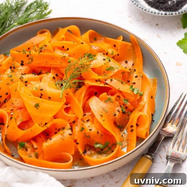 Moist Carrot Cake Loaf with Cream Cheese Glaze 15 An image of raw carrot salad on a serving plate with two forks on the side.