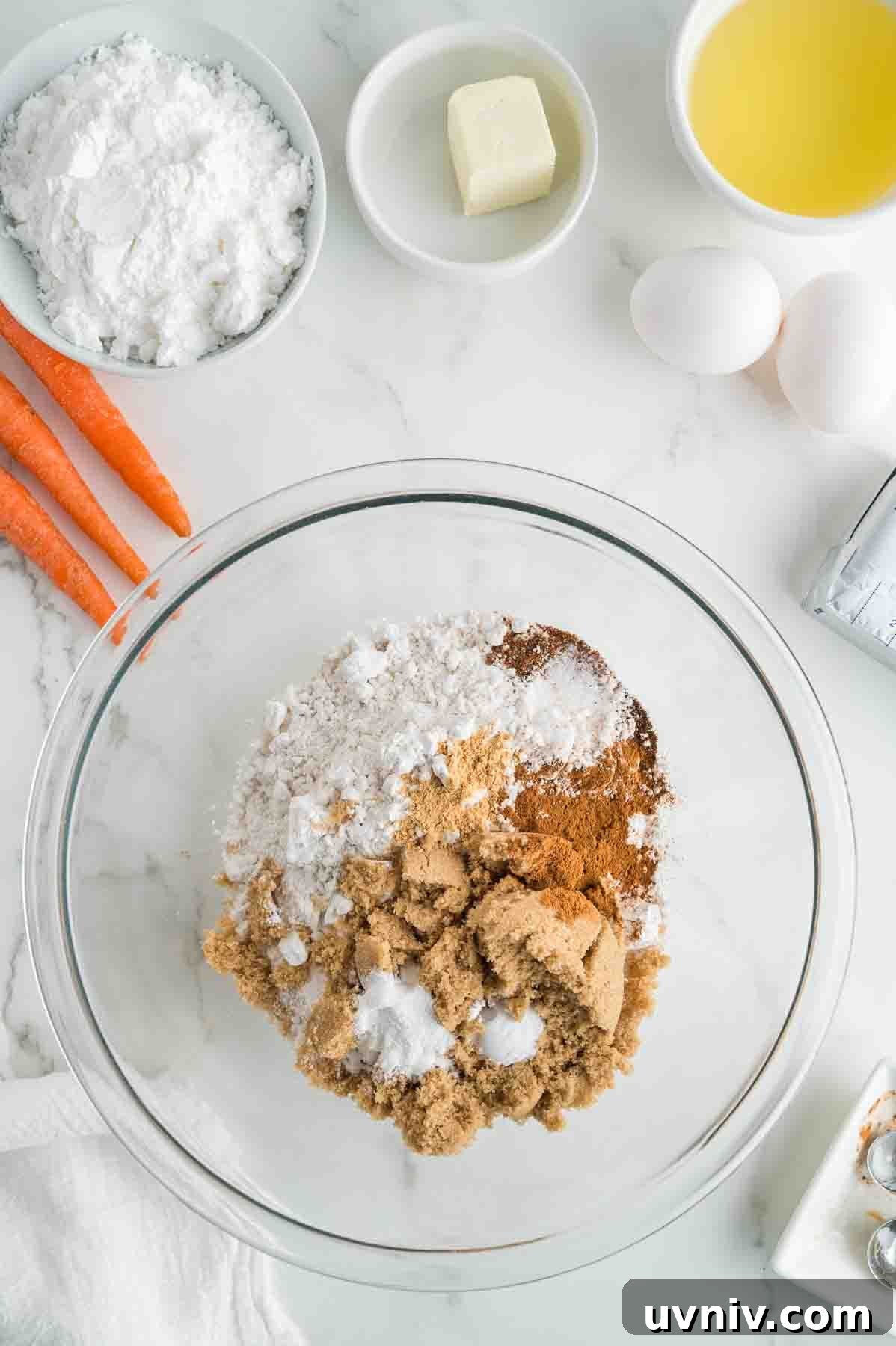 Moist Carrot Cake Loaf with Cream Cheese Glaze 4 An overhead image of combining the dry ingredients in a bowl.