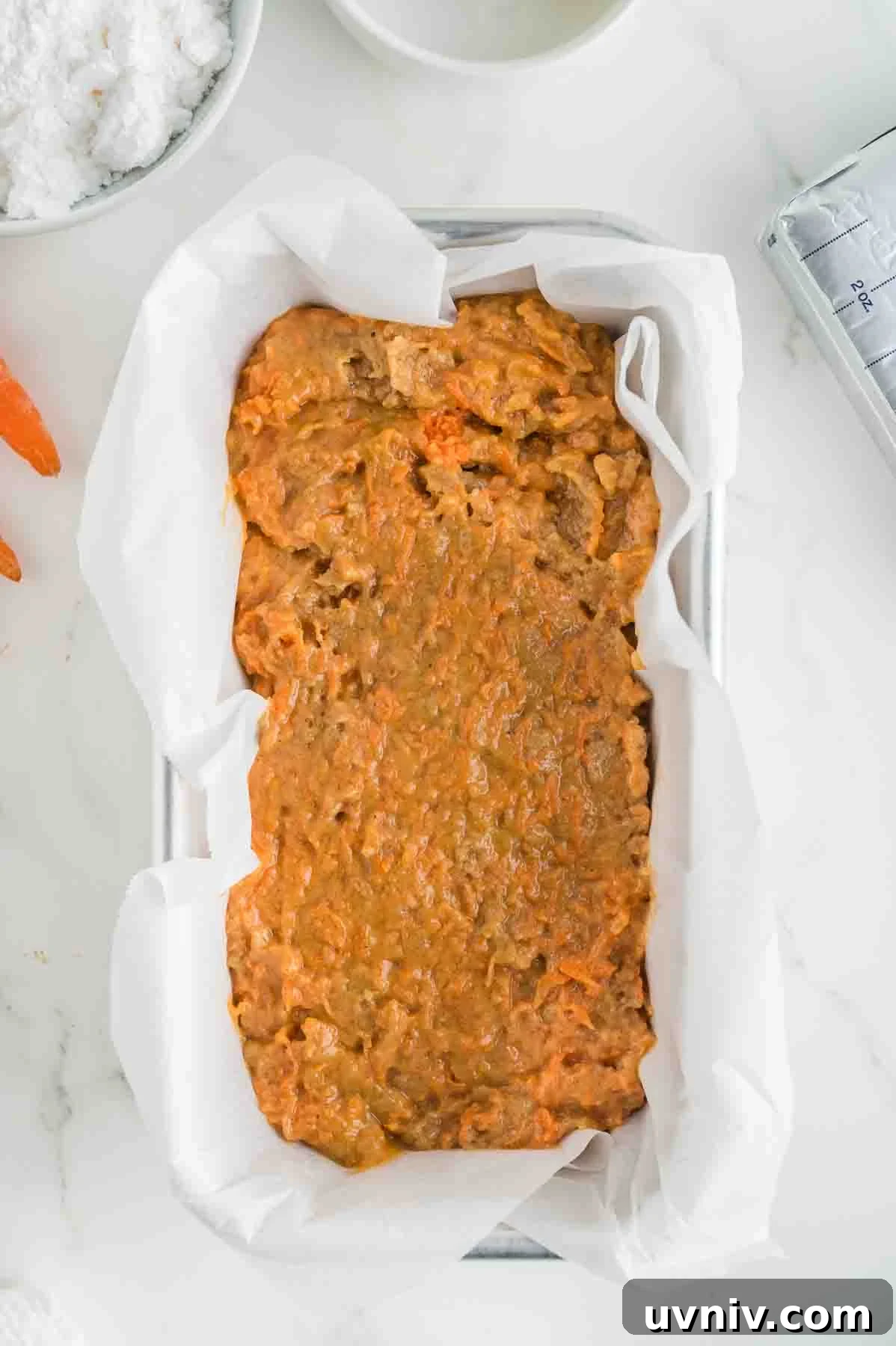 Moist Carrot Cake Loaf with Cream Cheese Glaze 8 An overhead image of the carrot cake loaf batter in a loaf pan.