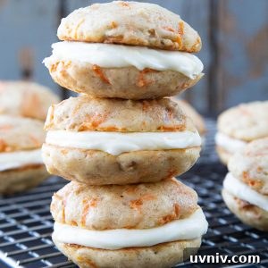Carrot Cake Whoopie Pies Recipe: Soft Spiced Sandwich Cookies 8 3 carrot cake whoopie pies stacked on a wire rack.