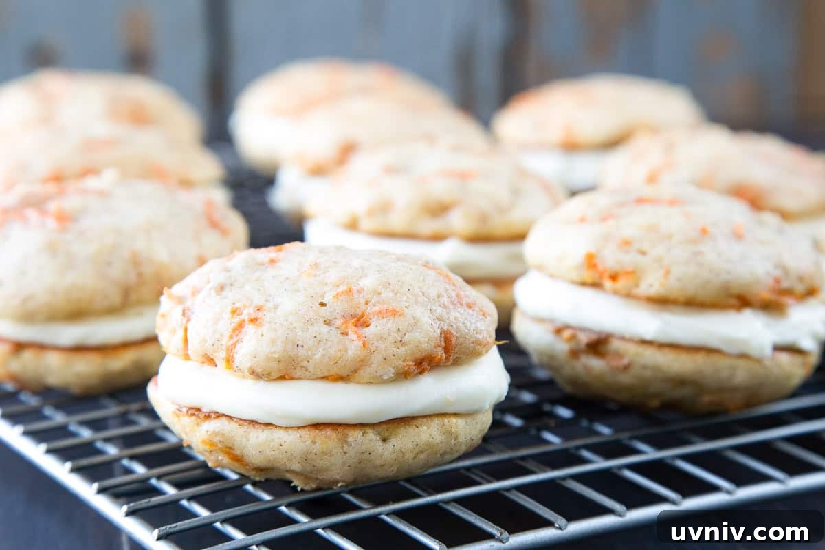 Carrot Cake Whoopie Pies Recipe: Soft Spiced Sandwich Cookies 3 carrot cake whoopie pies on a wire rack.