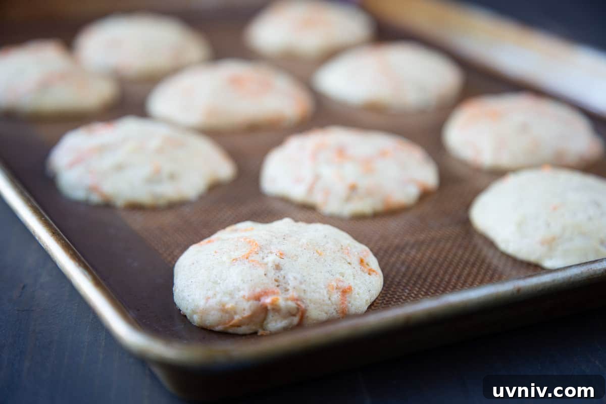 Carrot Cake Whoopie Pies Recipe: Soft Spiced Sandwich Cookies 5 baked flat carrot cakes on a baking sheet.
