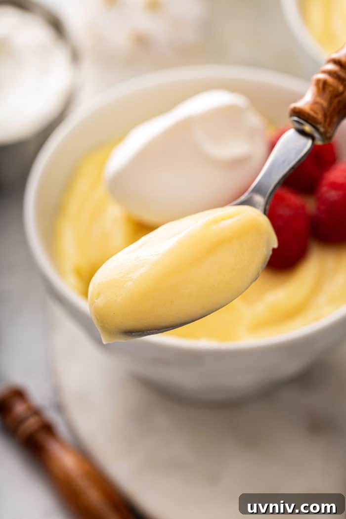 Spoonful of vanilla pudding being held up to the camera