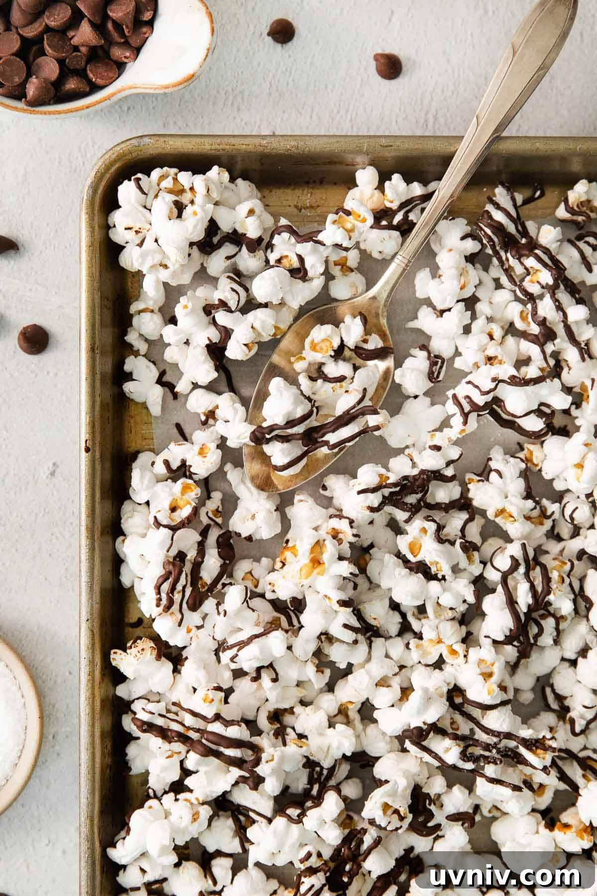 Chocolate Drizzle Popcorn Recipe: Sweet, Crunchy Movie Treat 2 Chocolate drizzle popcorn on a baking sheet