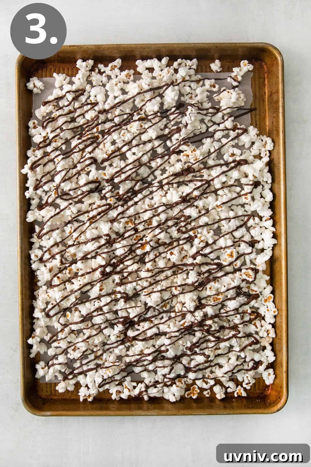 Chocolate Drizzle Popcorn Recipe: Sweet, Crunchy Movie Treat 6 Chocolate drizzle popcorn on a baking sheet