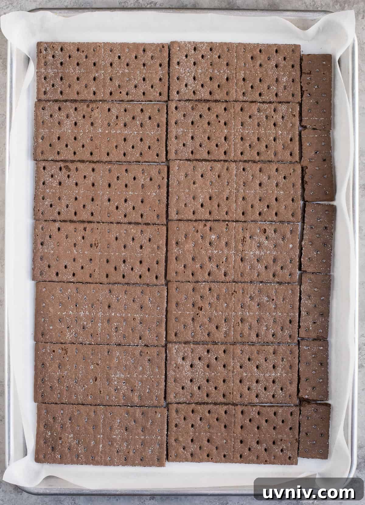 Chocolate Peppermint Bark Recipe for Holidays & Gift Giving 5 chocolate graham crackers in a single layer on a baking sheet