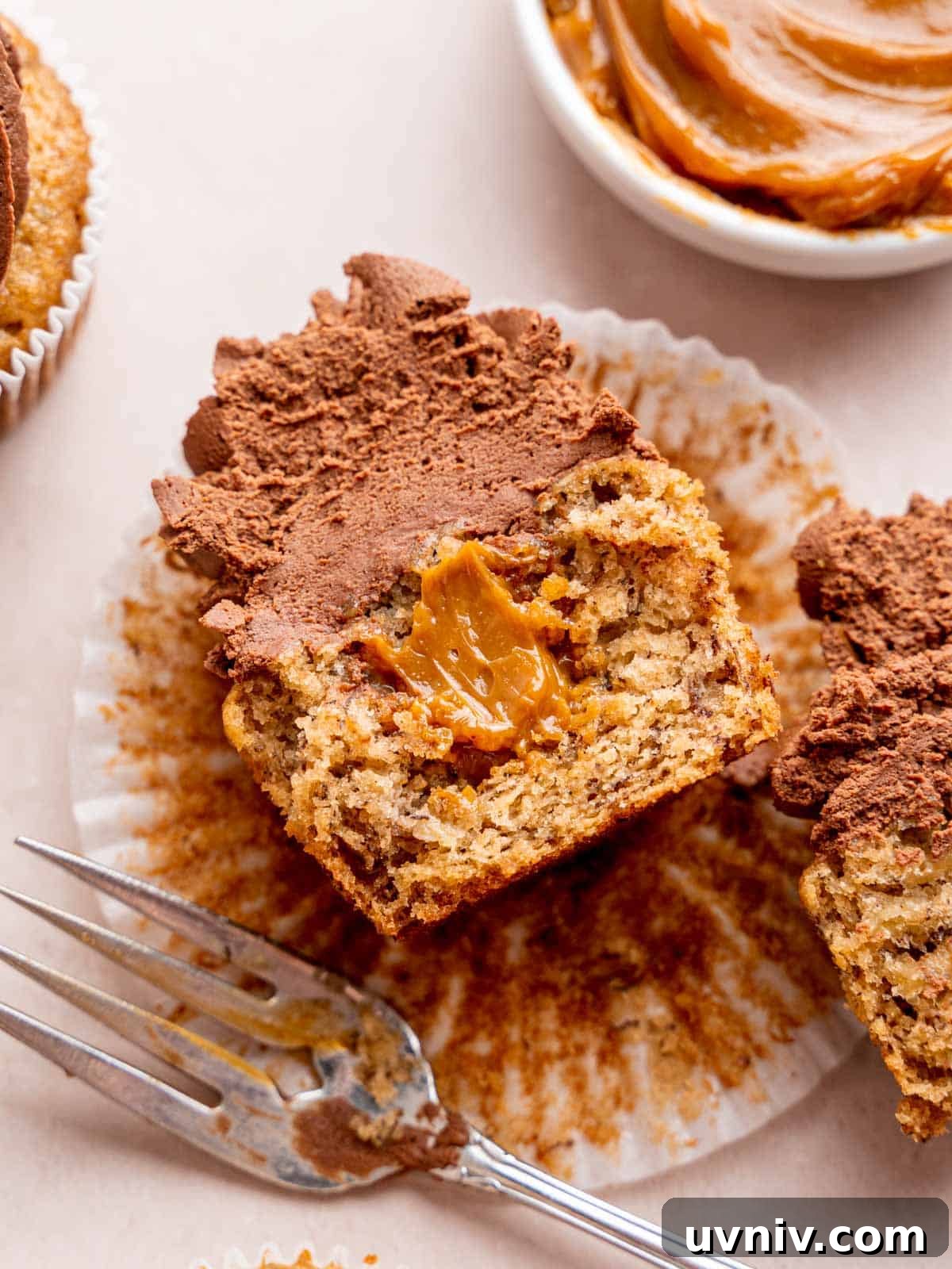 Banoffee Cupcakes Recipe: Caramel Banana Cupcakes with Toffee Frosting 2 A banoffee cupcake cut in half showing the dulce de leche filling.