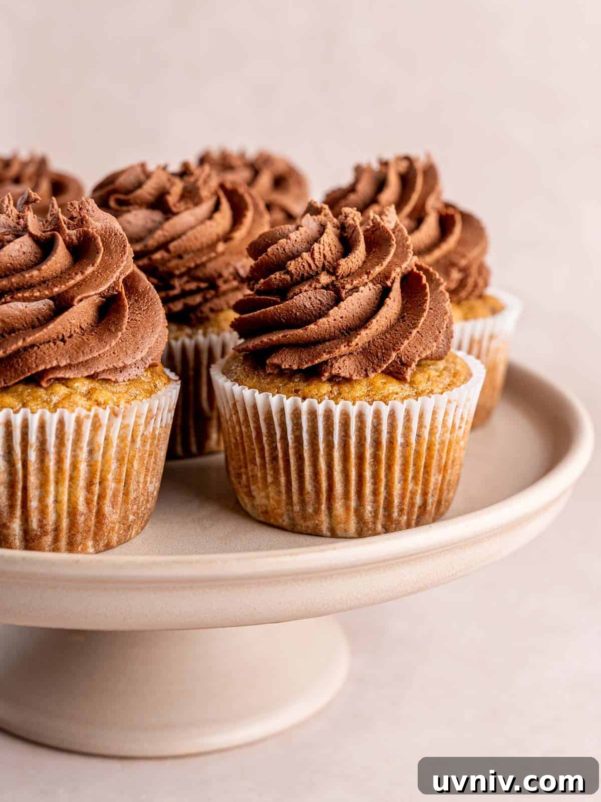 Banoffee Cupcakes Recipe: Caramel Banana Cupcakes with Toffee Frosting 12 Banoffee cupcakes on a cake stand.