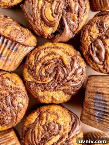 Banana muffins with Nutella swirled on top and in the middle.
