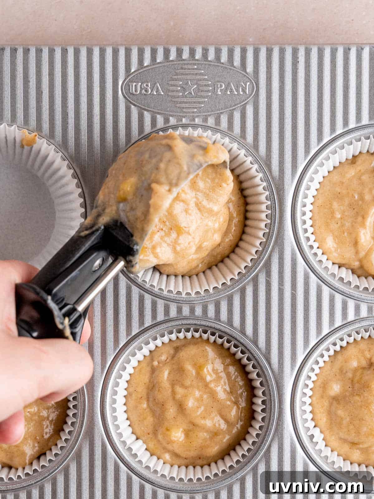Banoffee Cupcakes Recipe: Caramel Banana Cupcakes with Toffee Frosting 8 Scooping banana batter into cupcake liners.