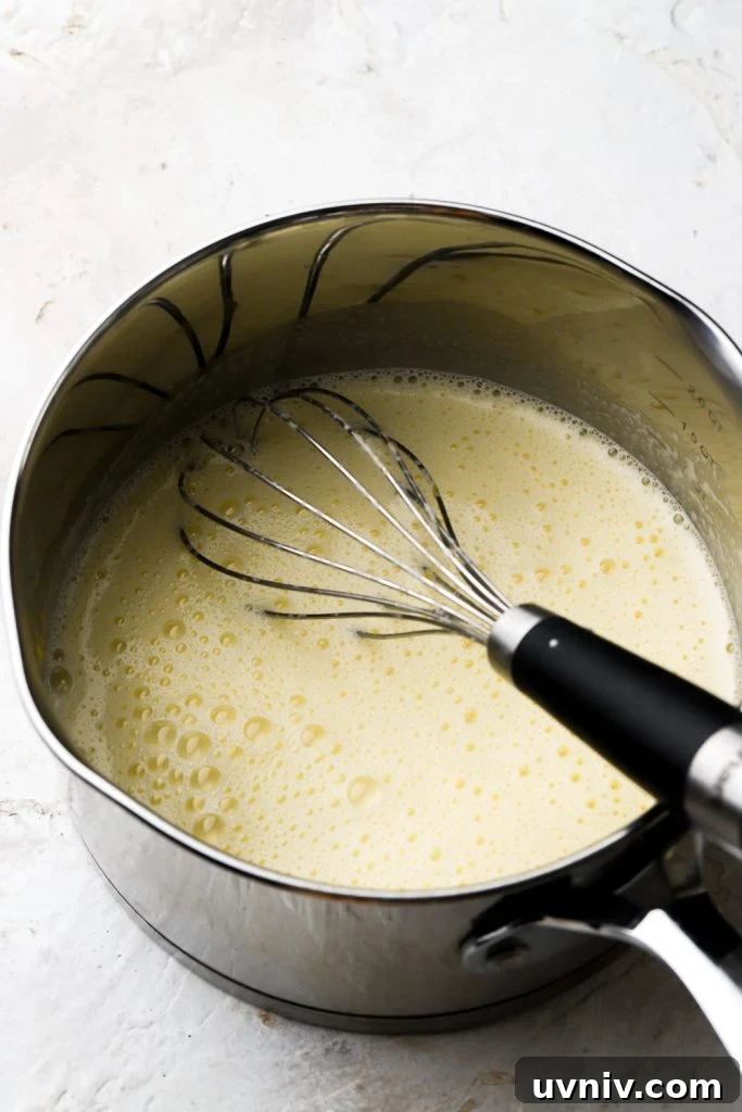 Party-Size Vanilla Birthday Sheet Cake Recipe 14 eggs tempered with milk in saucepan