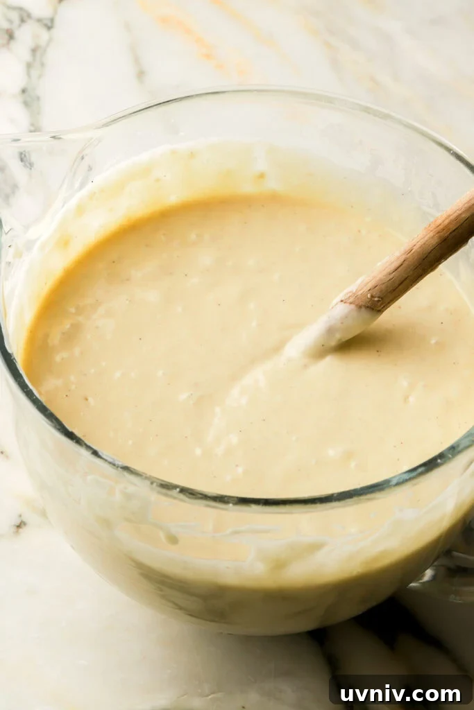 Party-Size Vanilla Birthday Sheet Cake Recipe 9 finished cake batter in a glass bowl with spatula in bowl