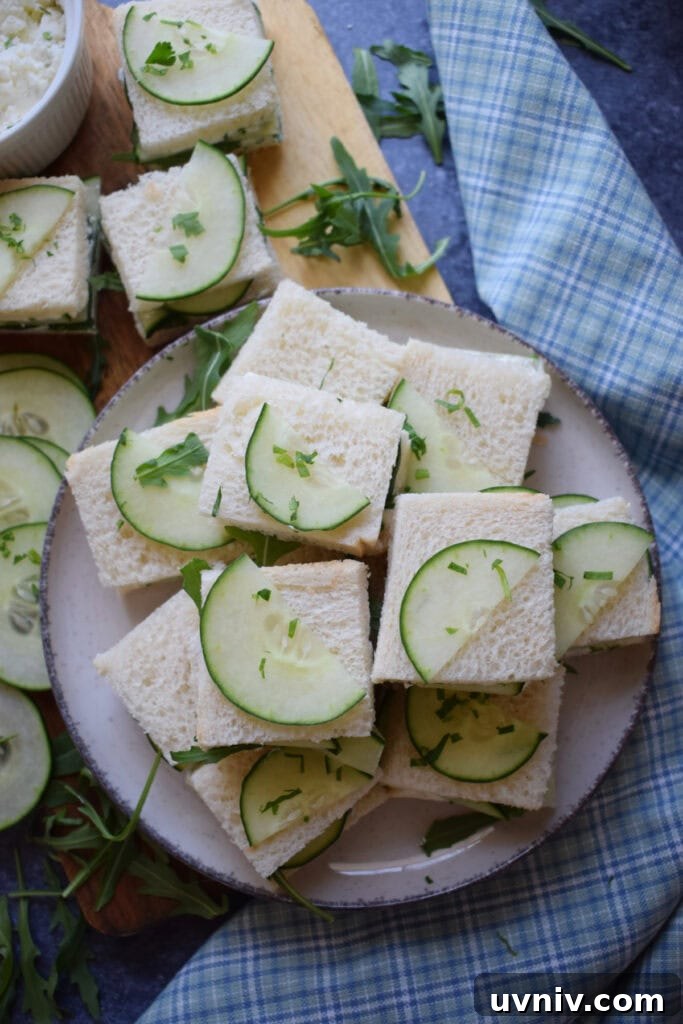 Small cucumber sandwiches on a plate.