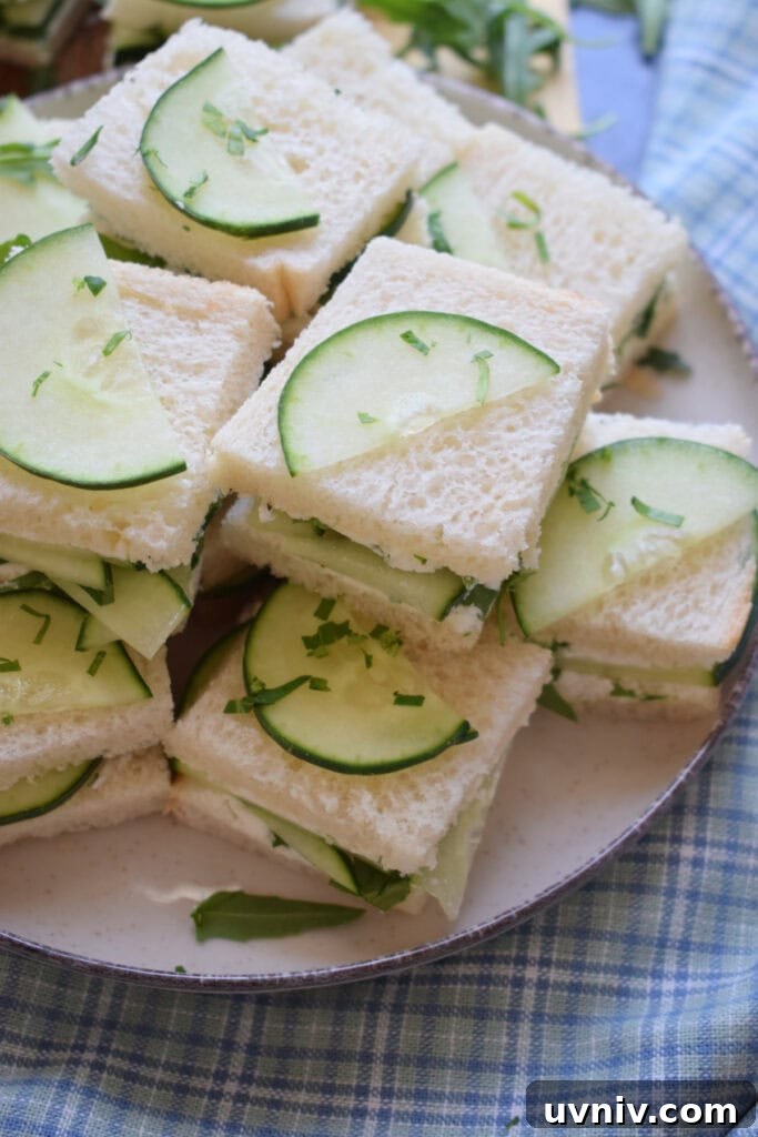 Mini cucumber tea sandwiches on a plate.