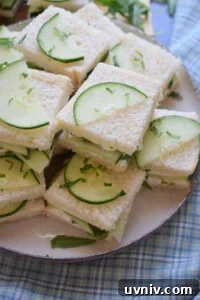 Mini cucumber tea sandwiches on a plate.