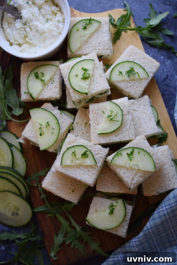 Cucumber sandwiches on a wooden board.