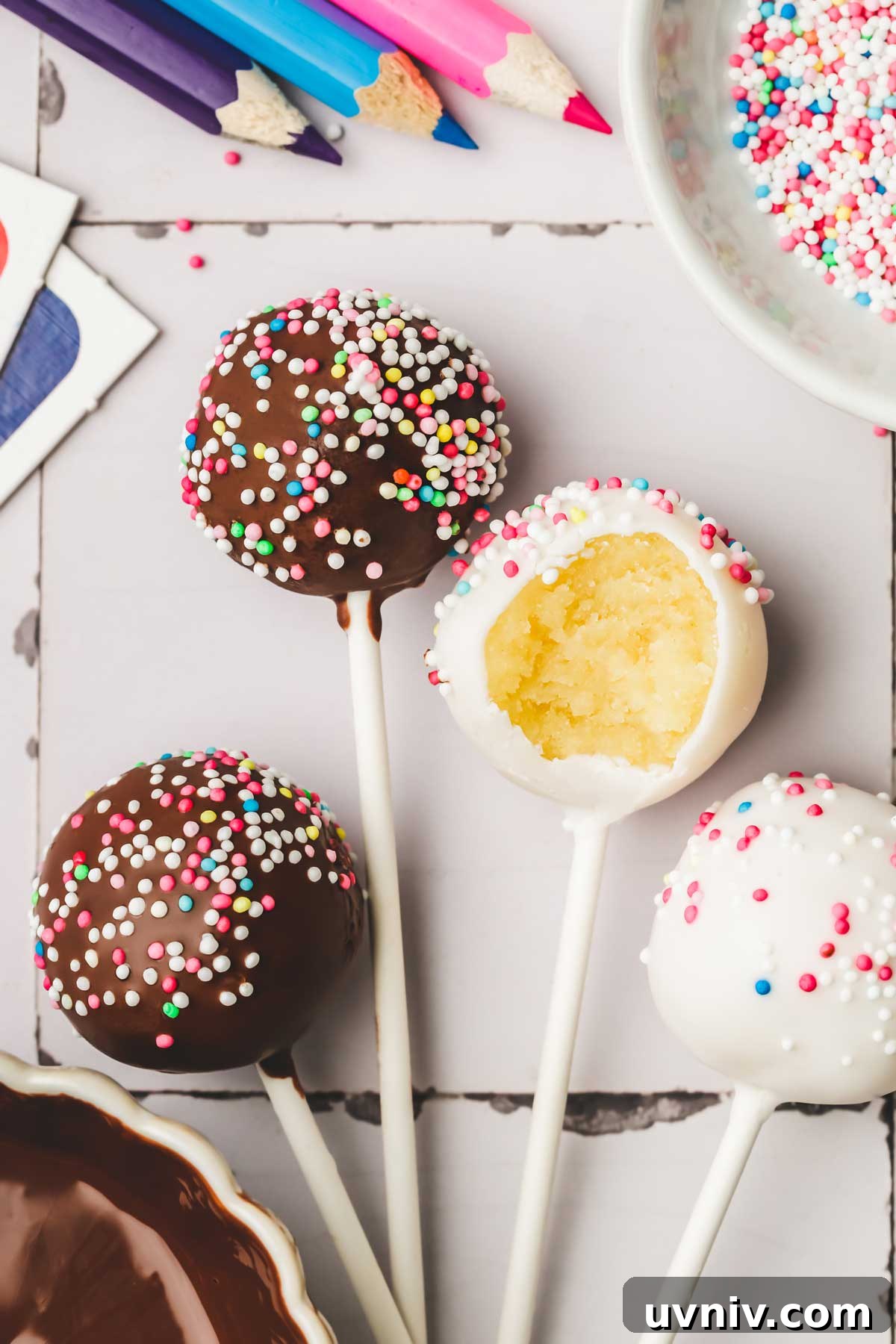 Homemade Vanilla Cake Pops Recipe: Step-by-Step Guide 9 Decorated cake pops on a table with colorful sprinkles