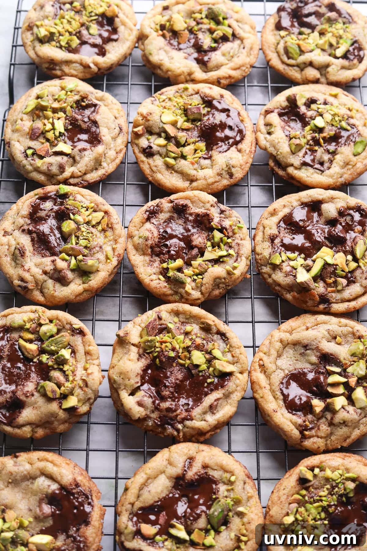 Brown Butter Pistachio Chocolate Chip Cookies Recipe 9 Freshly baked brown butter pistachio chocolate chip cookies on a cooling rack.