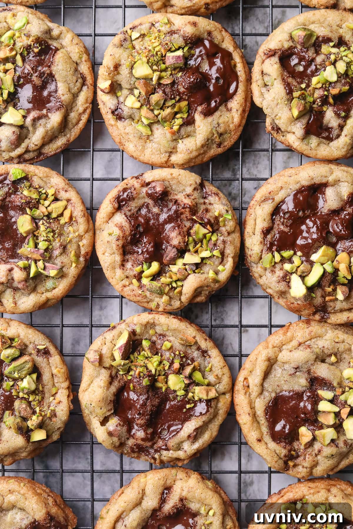 Brown Butter Pistachio Chocolate Chip Cookies Recipe 10 Brown butter pistachio chocolate chip cookies on a cooling rack.