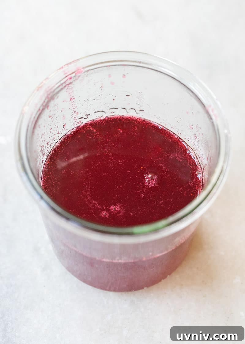 Cranberry and Thyme Gin & Tonic Recipe for Holiday Cocktails 5 homemade cranberry simpel syrup in a glass jar