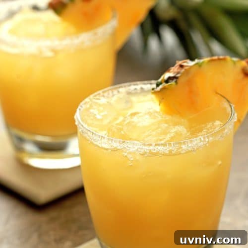 Pineapple Margarita Recipe: Tropical Cocktail Guide 9 Duo of Pineapple Margaritas served with Pineapple wedge for garnish.