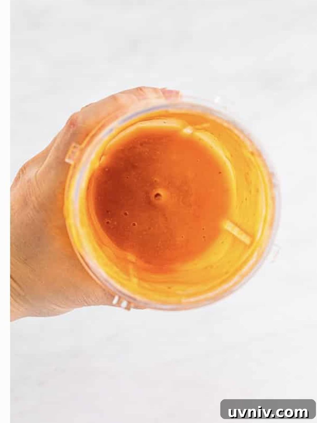 Smooth blended peach and raspberry puree for a peach bellini.