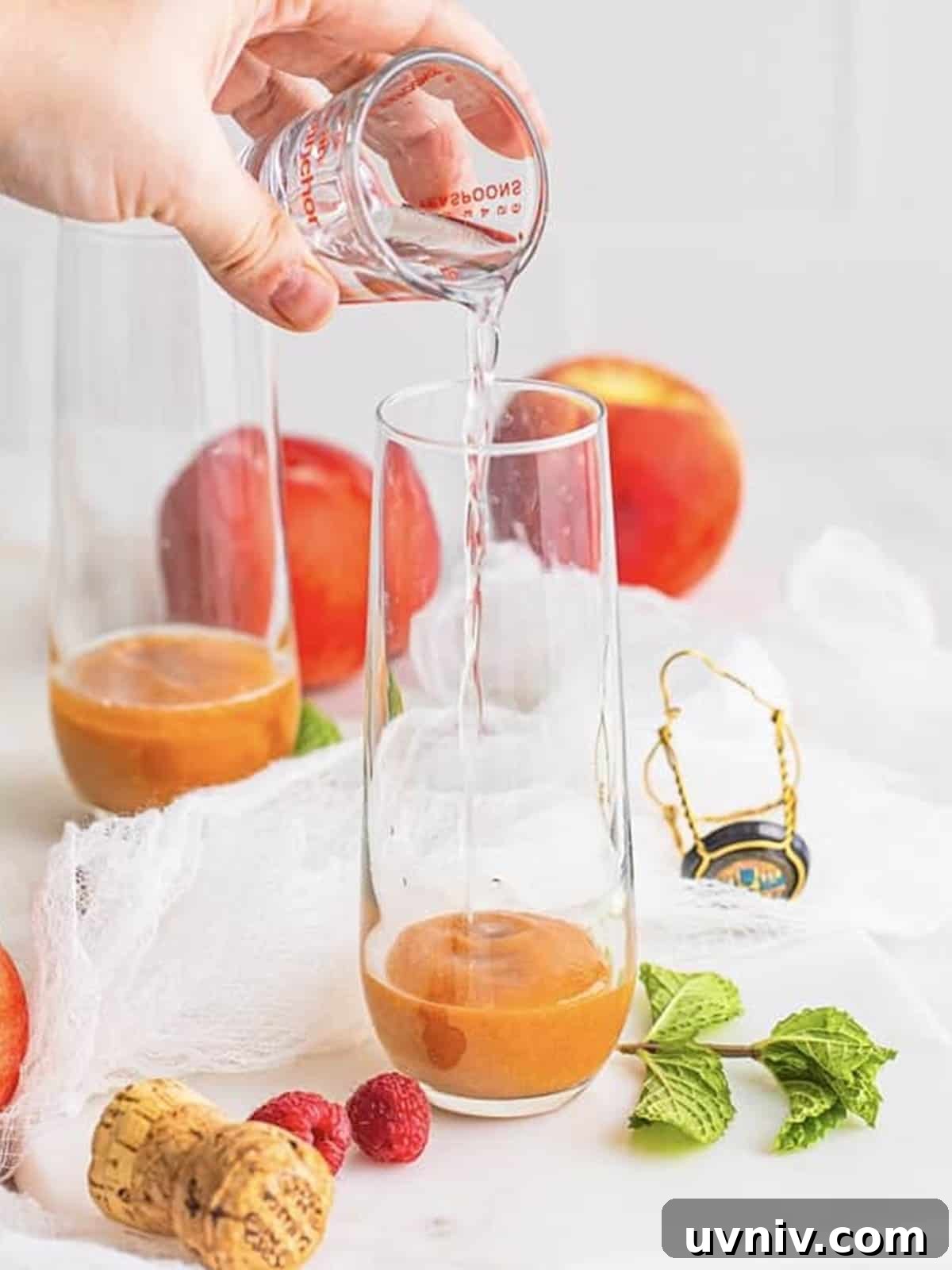 Peach puree and peach schnapps layered in the bottom of a champagne glass.