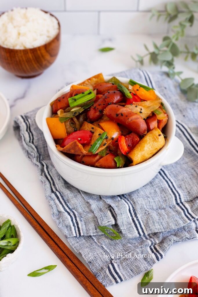 Spicy Korean Sausage Stir-Fry with Vegetables 2 A bowl of sausage bokkeum served with a side of white rice.