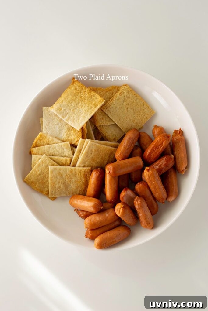 Spicy Korean Sausage Stir-Fry with Vegetables 4 A plate of fish cake sheets cut into squares and sausages with shallow diagonal cuts.