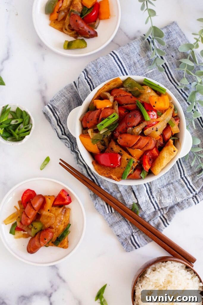 Spicy Korean Sausage Stir-Fry with Vegetables 8 Top down view of the sausage stir fry garnished with green onion and served with white rice.