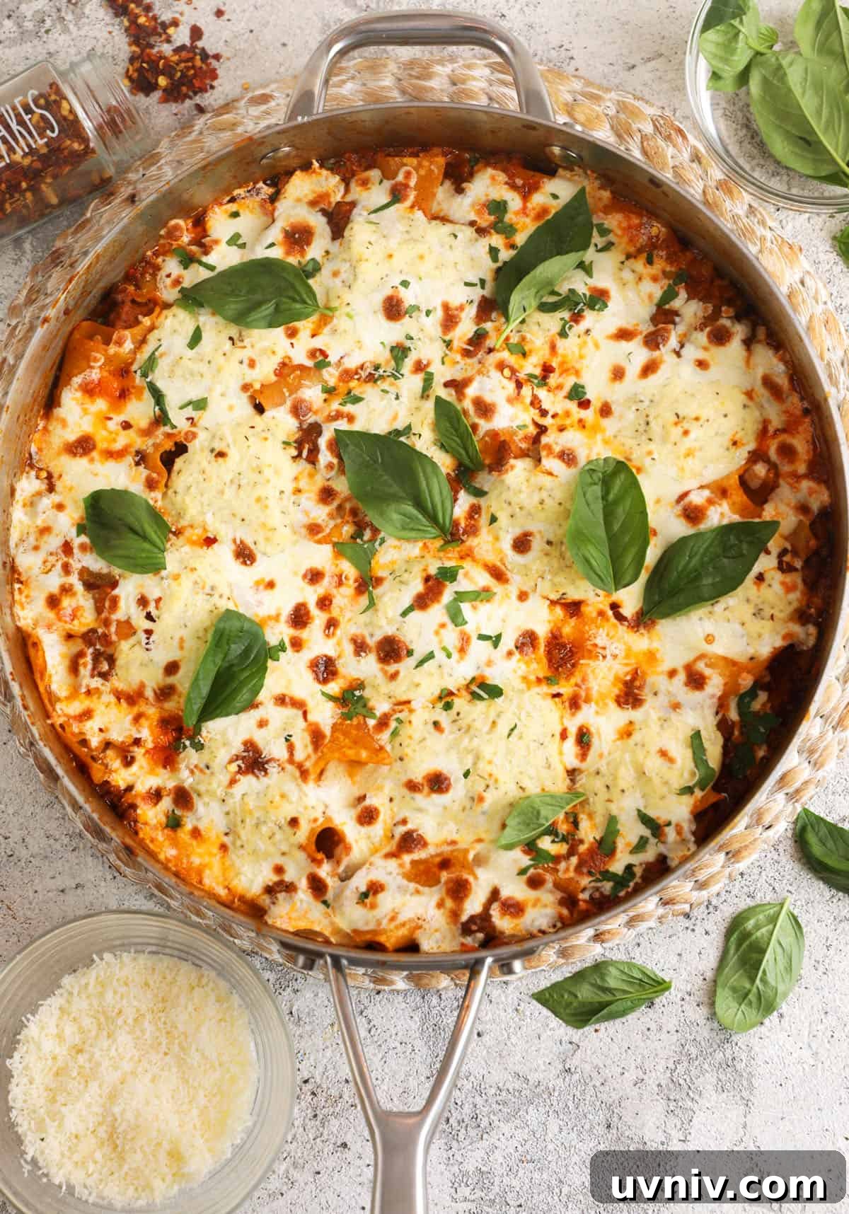 Overhead view of cheesy skillet lasagna with basil for garnish