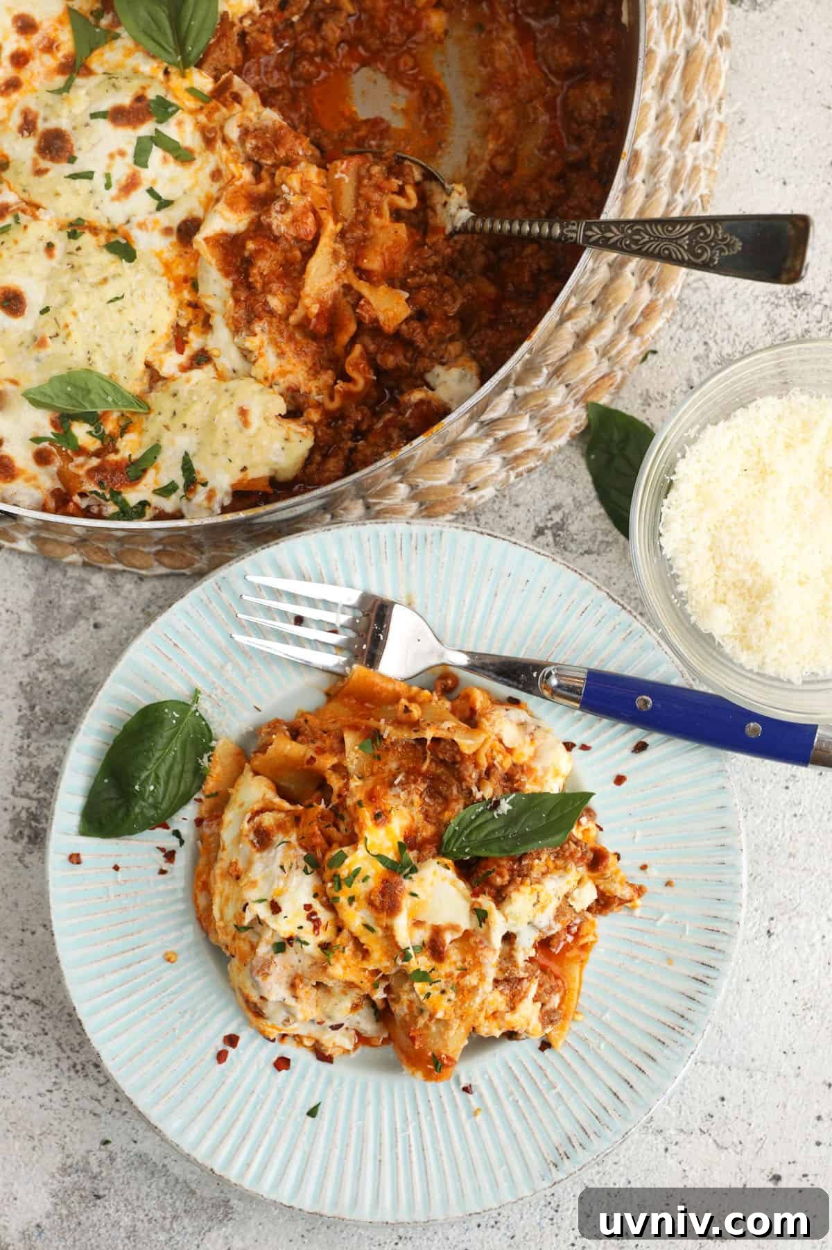 Overhead view of skillet lasagna on plate and in pan