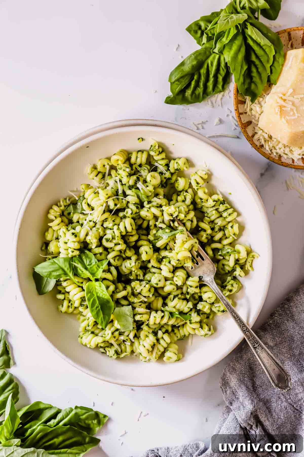 Creamy Basil Pesto Pasta Recipe for Quick Weeknight Meals 3 A bowl of basil pesto pasta with a fork on top.