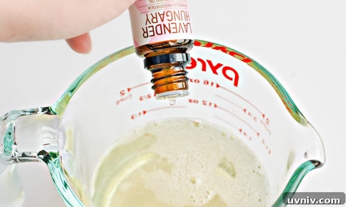 a drop of lavender essential oil being added to soap mixture
