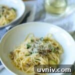 bowl of mushroom zucchini pasta topped with cheese