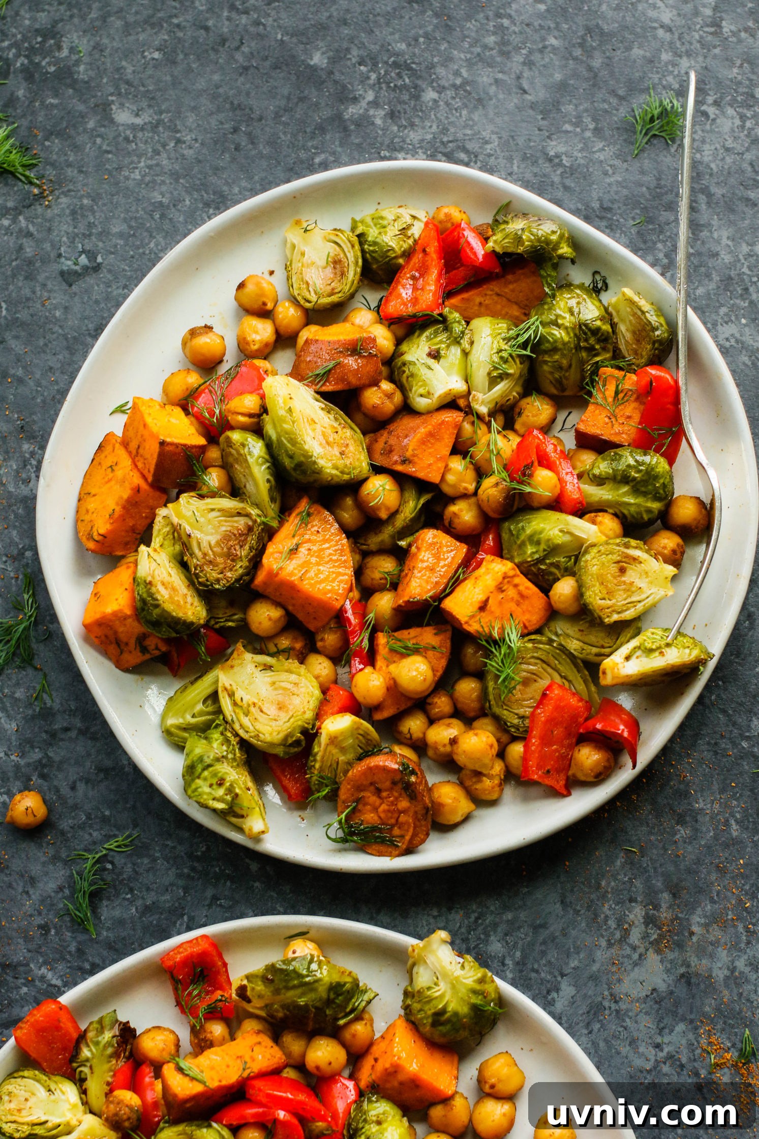 Sweet Potato & Chickpea Bake served on plates with forks and fresh dill by Flora & Vino