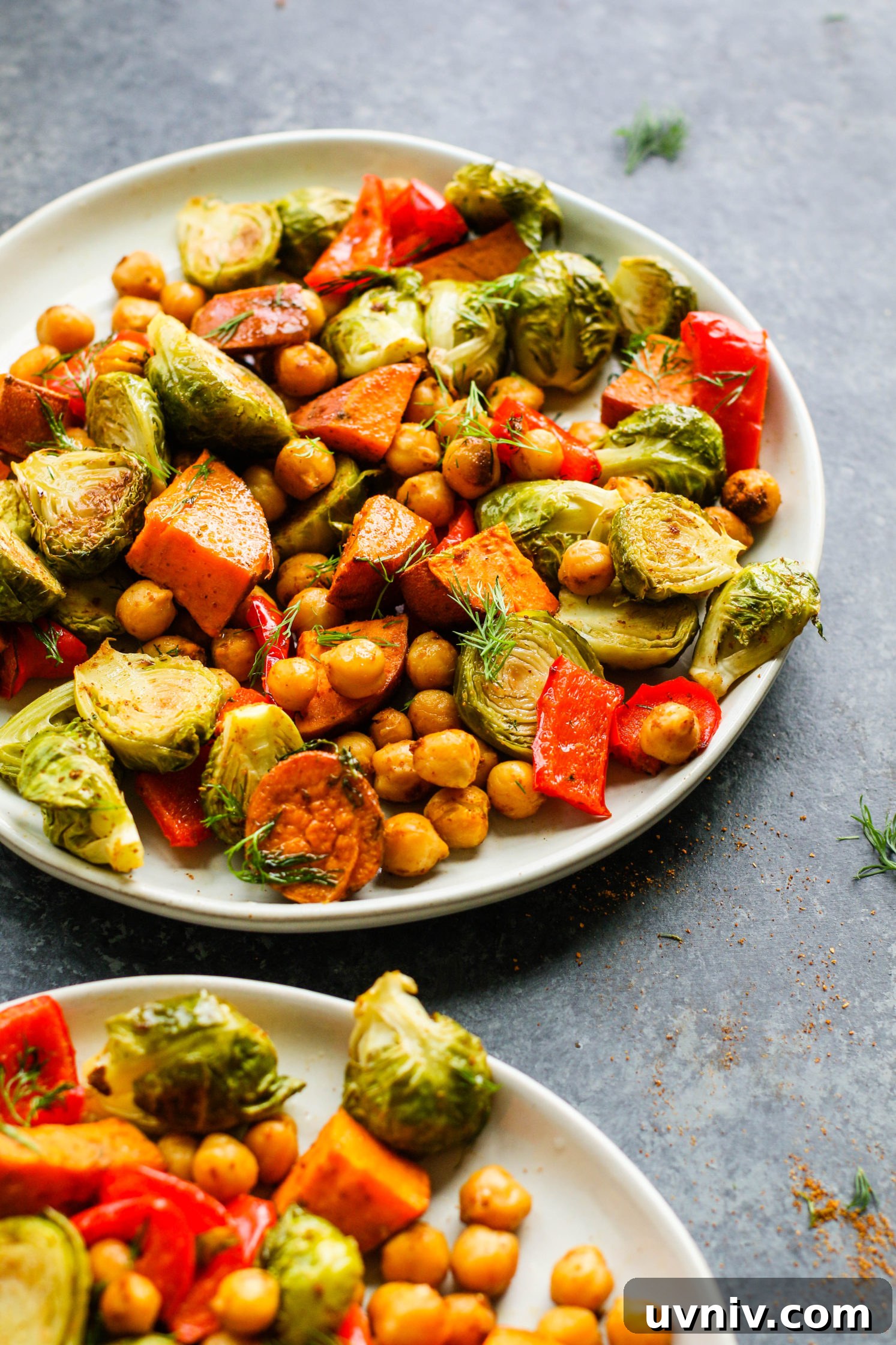 Sweet Potato & Chickpea Bake served on plates with fresh dill by Flora & Vino