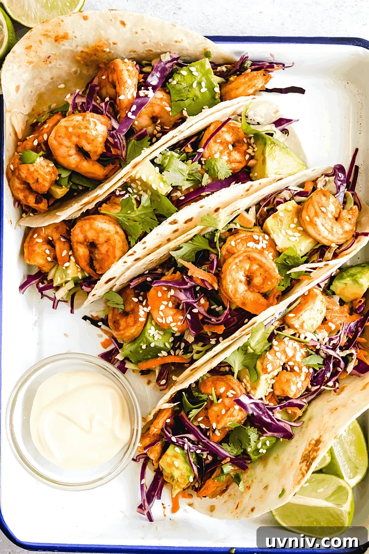 Four Shrimp Tacos Topped with Asian Slaw on a Serving Platter