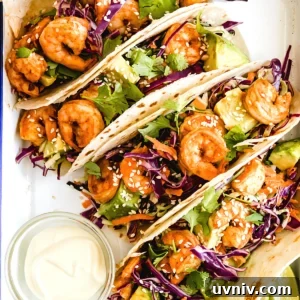 Four Shrimp Tacos Topped with Asian Slaw on a Serving Platter