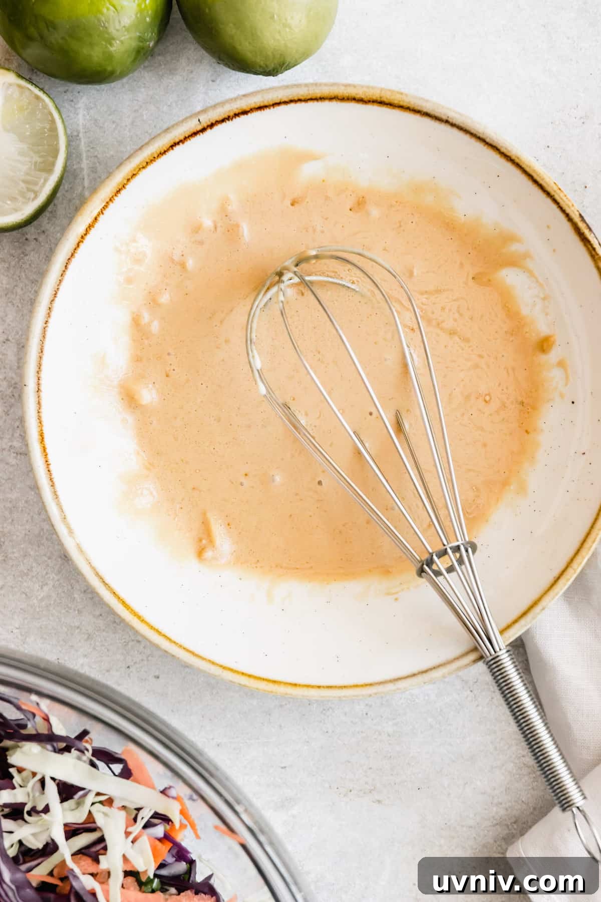 Asian Dressing in a White Bowl with a Whisk