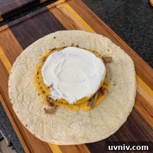 Crunchwrap Supreme with Pulled Pork: Copycat Recipe & Tips 17 tostada shell topped with sour cream
