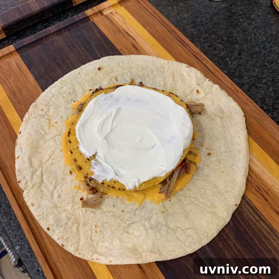 Crunchwrap Supreme with Pulled Pork: Copycat Recipe & Tips 7 tostada shell topped with sour cream